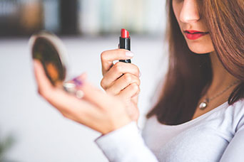 image of women using lipstick